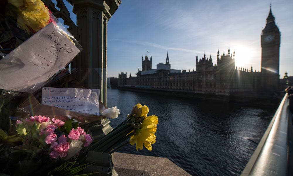 Floral tributes with Houses of Parliament in background