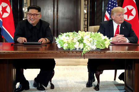 U.S. President Donald Trump and North Korea's leader Kim Jong Un hold a signing ceremony at the conclusion of their summit at the Capella Hotel on the resort island of Sentosa, Singapore June 12, 2018. Picture taken June 12, 2018. REUTERS/Jonathan Ernst/Files