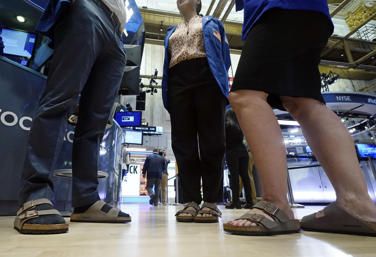 Traders on the floor of the New York Stock Exchange wear Birkenstock sandals during the company's IPO, Wednesday, Oct. 11, 2023, in New York. (AP Photo/Richard Drew)