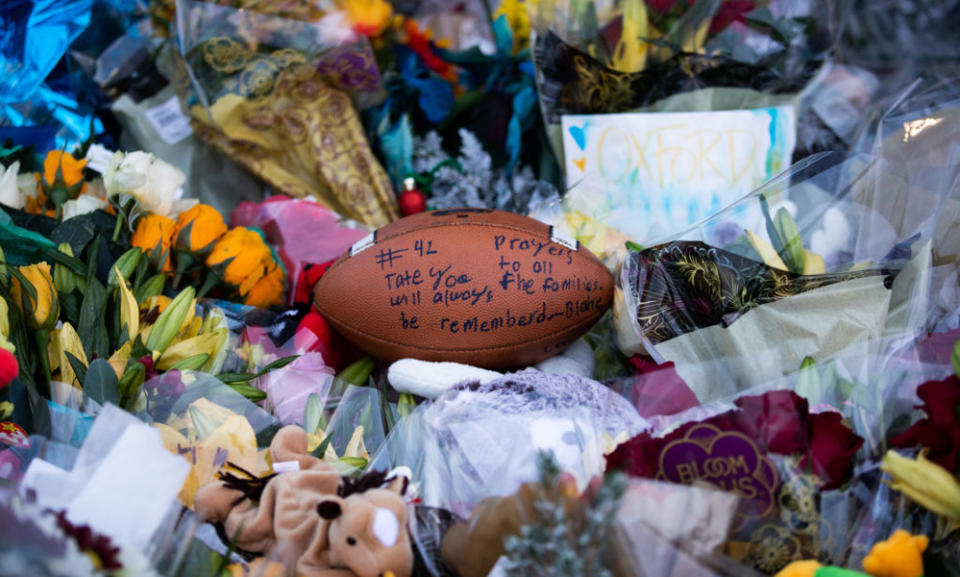 A football is among items left at a memorial outside of Oxford High School after four students were killed and seven others injured in a Nov. 30, shooting. (Emily Elconin/Getty Images)