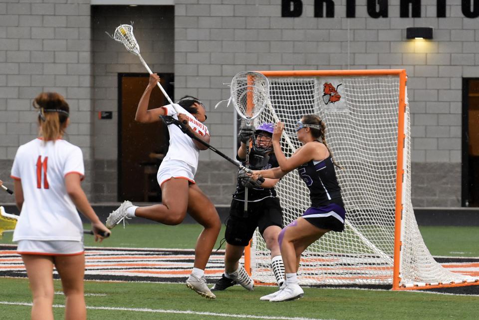 Brighton's Amaria Whitby flips a shot over her shoulder to score in a 14-7 victory over Bloomfield Hills in a Division 1 state semifinal lacrosse game on Wednesday, June 8, 2022 at Brighton.