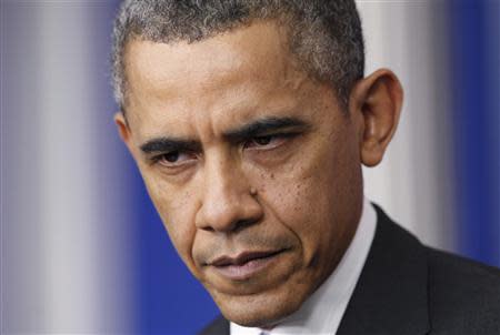 President Barack Obama pauses during his his year-end news conference in the White House briefing room in Washington, December 20, 2013. REUTERS/Jonathan Ernst