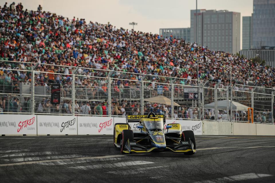 Music City Grand Prix polesitter Colton Herta races by packed grandstands in Sunday's Nashville street race.