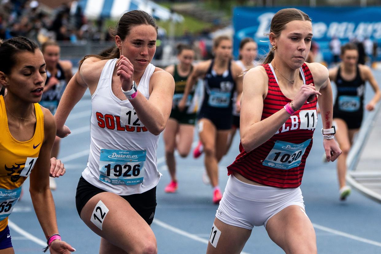 Solon's Gracie Federspiel (left) and Gilbert's Sarah Feddersen run the girls 800 meter run during the Drake Relays at Drake Stadium on Friday.