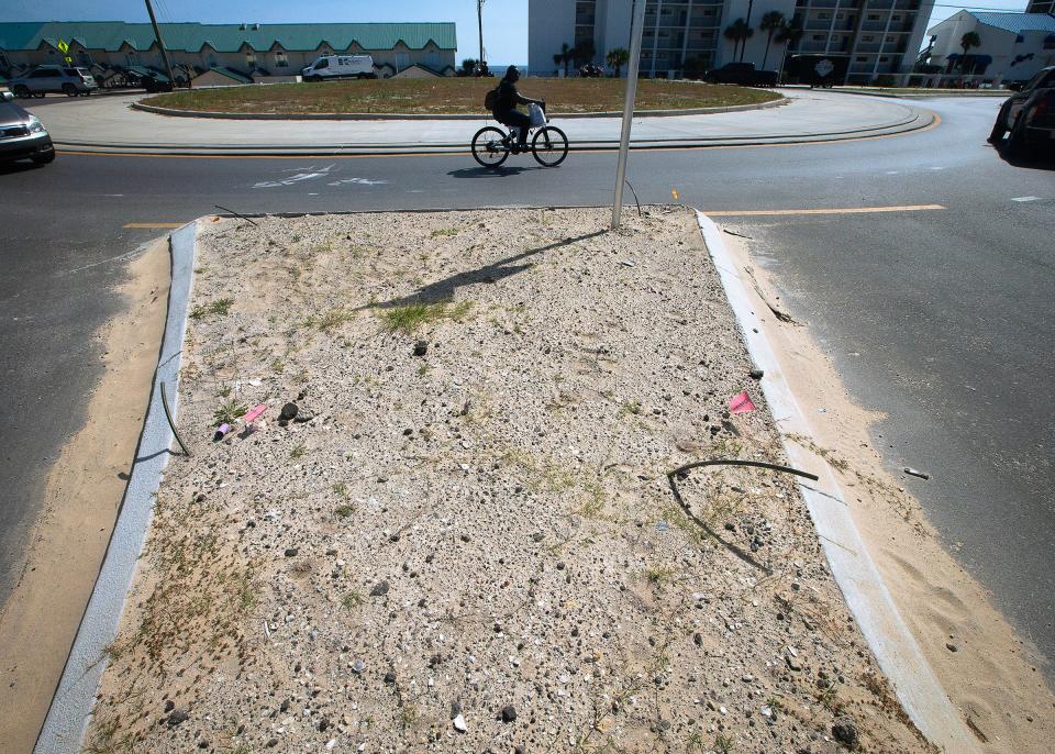 A bicyclist cruises the roundabout at Front Beach Road and South Arnold in Panama City Beach.