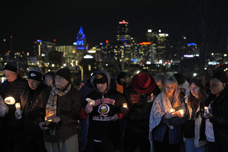 People attend a candlelight vigil for victims of a shooting at a Kansas City Chiefs Super Bowl victory rally Thursday, Feb. 15, 2024 in Kansas City, Mo. More than 20 people were injured and one woman killed in the shooting near the end of Wednesday's rally held at nearby Union Station. (AP Photo/Charlie Riedel)