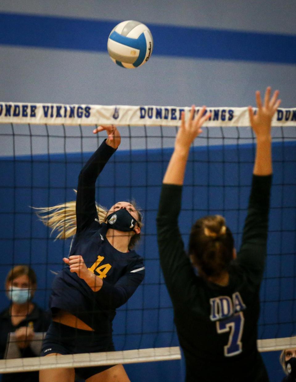 Airport's Julia Mills hits during a game against Ida last season. Mills was selected as the 2021 Monroe County Region Volleyball Player of the Year by the Monroe News.