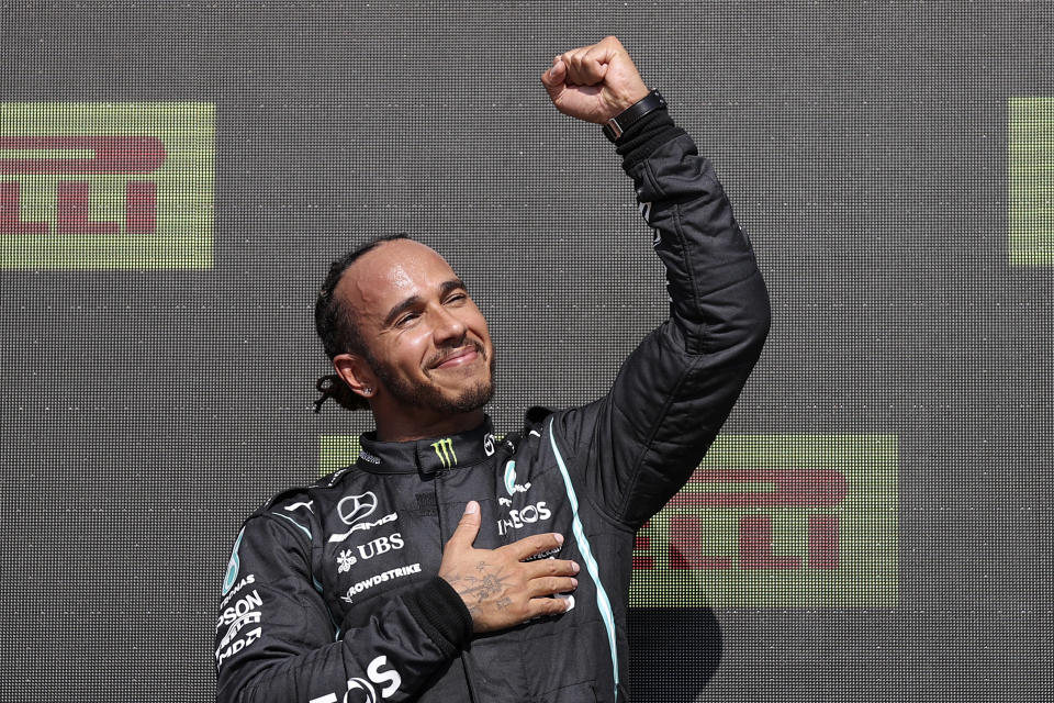 Mercedes driver Lewis Hamilton of Britain celebrates on the podium after winning the British Formula One Grand Prix, at the Silverstone circuit, in Silverstone, England, Sunday, July 18, 2021. (Lars Baron/Pool photo via AP)