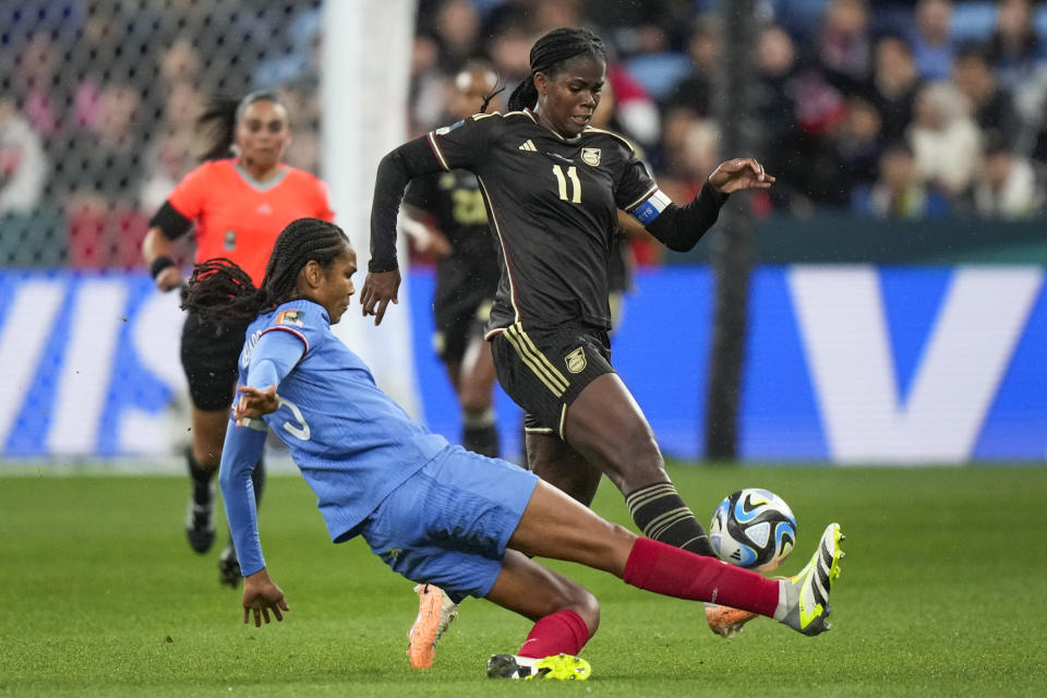 Jamaica's Khadija Shaw, right, battles for the ball with France's Wendie Renard during the Women's World Cup Group F soccer match between France and Jamaica at the Sydney Football Stadium in Sydney, Australia, Sunday, July 23, 2023. (AP Photo/Rick Rycroft)