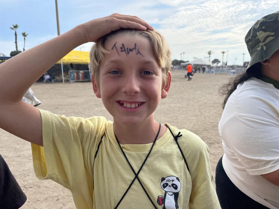 Twelve-year-old Ryland Murphy of Ojai shows off Tony Hawk’s autograph Saturday at X Games Ventura.