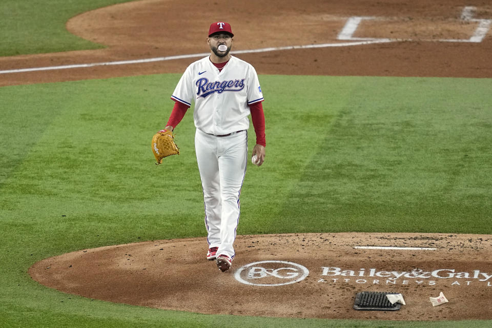 Texas Rangers starting pitcher Martin Perez walks to the back of the mound after giving up a run-scoring single to St. Louis Cardinals' Paul DeJong in the second inning of a baseball game, Monday, June 5, 2023, in Arlington, Texas. (AP Photo/Tony Gutierrez)