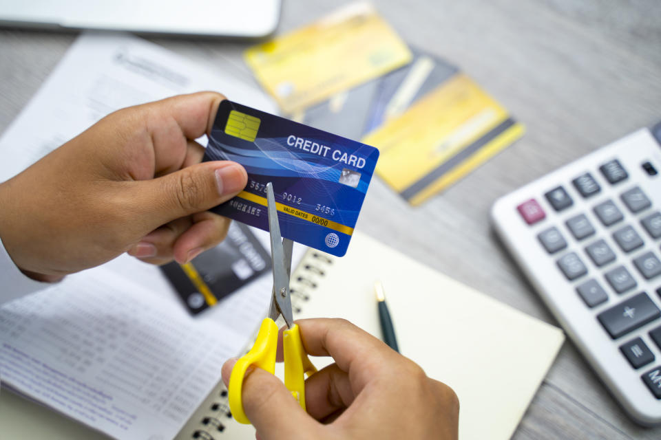 Scissors cutting a credit card in preparation for home loan approval.