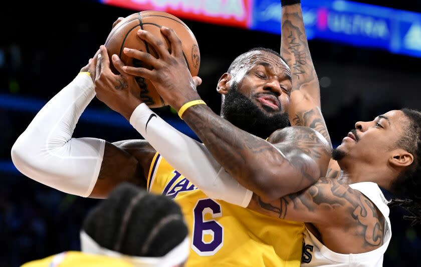 Los Angeles, California April 28, 2023-Lakers LeBron James grabs a rebound from Grizzlies Ja Morant in the first quarter in Game 6 of the NBA playoffs at Crypto.com arena Friday. (Wally Skalij/Los Angeles Times)