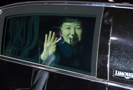 South Korea's ousted leader Park Geun-hye sitting inside a vehicle waves to her supporters upon her arrival to her private house in Seoul, South Korea, March 12, 2017. Seo Myeong-gon/Yonhap via REUTERS