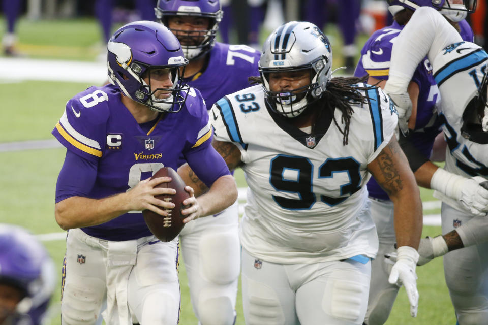 Minnesota Vikings quarterback Kirk Cousins (8) runs from Carolina Panthers defensive tackle Bravvion Roy (93) during the second half of an NFL football game, Sunday, Nov. 29, 2020, in Minneapolis. (AP Photo/Bruce Kluckhohn)