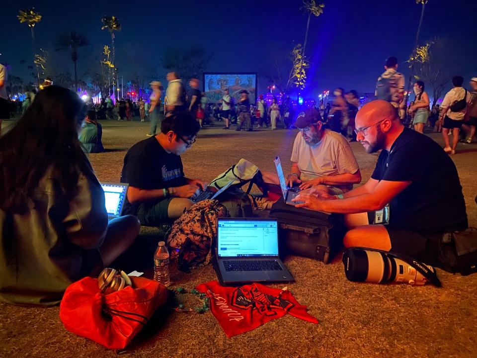 Desert Sun employees Eliana Perez, Kevin Caparoso, Shad Powers and Andy Abeyta hard at work between the main stage and "Spectra" art installation Sunday, April 23, 2023 at the Coachella Valley Music and Arts Festival at Empire Polo Club in Indio, Calif.