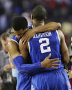 After Kentucky guard Aaron Harrison (2) made a three-point basket in the final seconds against Wisconsin to win the game 74-73, he is embraced guard Andrew Harrison after their NCAA Final Four tournament college basketball semifinal game Saturday, April 5, 2014, in Arlington, Texas. (AP Photo/Charlie Neibergall)