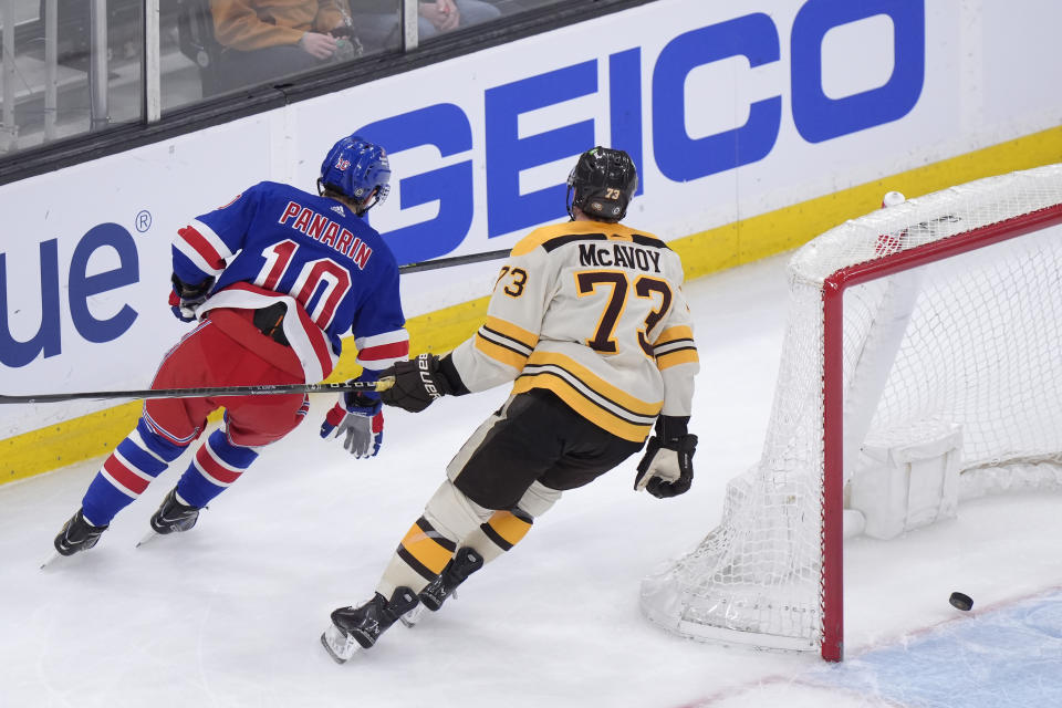 New York Rangers left wing Artemi Panarin (10) and Boston Bruins defenseman Charlie McAvoy (73) skate past the net after Panarin hit an empty-net goal in the third period of an NHL hockey game, Thursday, March 21, 2024, in Boston. (AP Photo/Steven Senne)