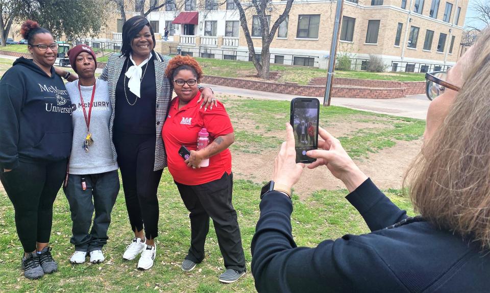 Robin Daniels, vice president of marketing and communications at McMurry University, takes a souvenir photo of basketball star Sheryl Swoopes (the tall one) with three of her fans before her luncheon speech Thursday.