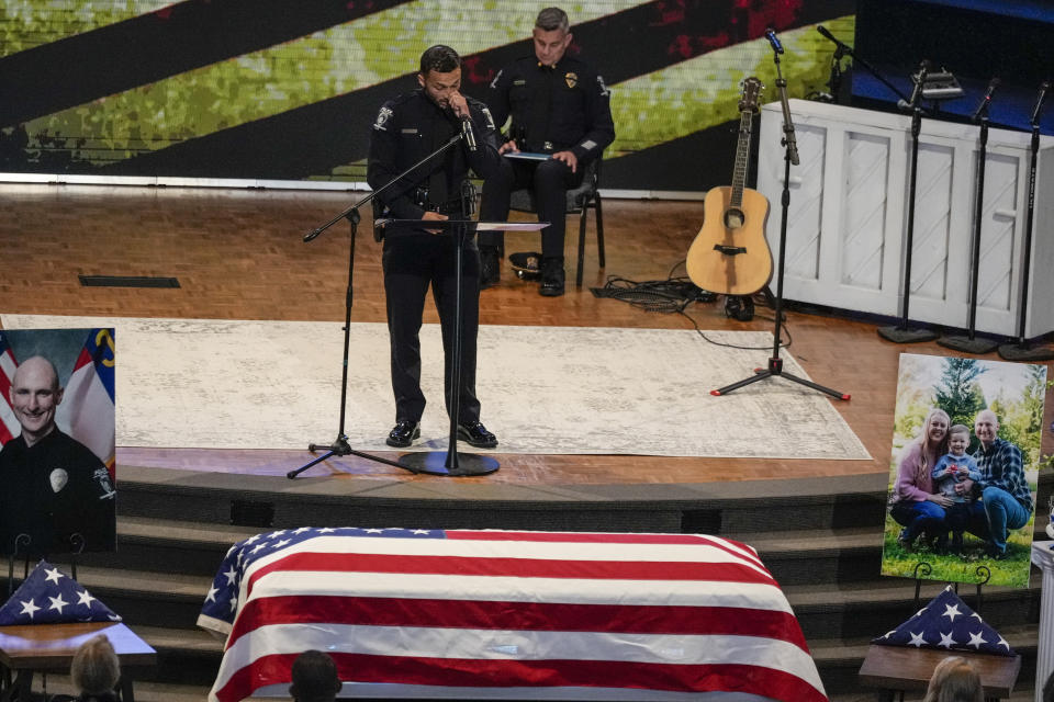 An officer speaks during a memorial service for Officer Joshua Eyer, Friday, May 3, 2024, in Charlotte, N.C. Police in North Carolina say a shootout that killed Eyer and wounded and killed other officers began as officers approached a home to serve a felony warrant on Monday. (AP Photo/Chris Carlson)