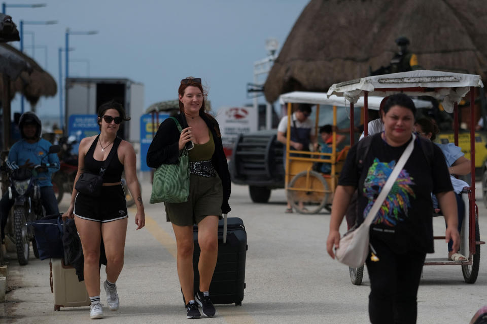 Mexicans with luggage evacuating.