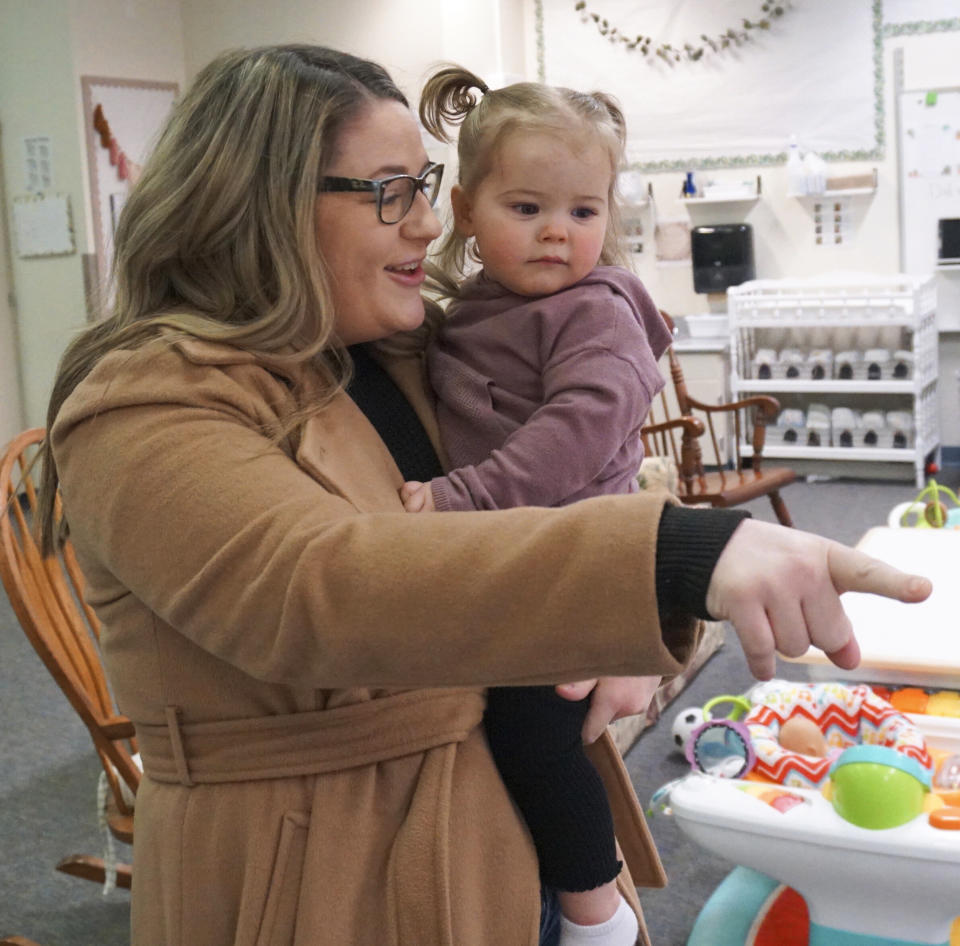 Christina Zimmerman, who teaches fourth grade at Endeavor Elementary, drops off her daughter Parker, 1, at the school's onsite daycare on Feb. 29, 2024, in Nampa, Idaho. (Carly Flandro/Idaho Education News via AP)