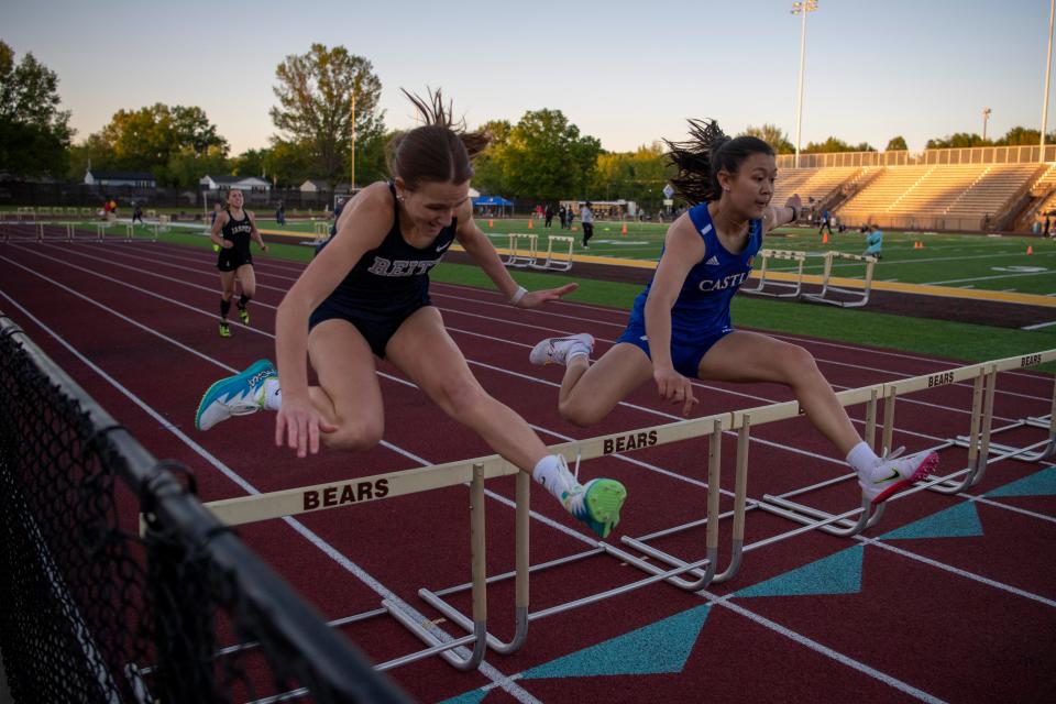 Reitz’s Adison Fuller, left, and Castle’s Sophia Quach clear hurdles in 300 meter hurdles during the 2023 Southern Indiana Athletic Conference Girls Track & Field meet at Central High School in Evansville, Ind.,,Wednesday, May 3, 2023.