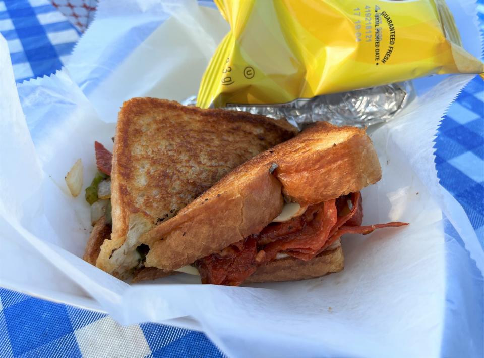 The Cheese Boss Food Truck features gourmet grilled cheese sandwiches, including the Pizza Grilled Cheese with  pepperoni, peppers and onions.