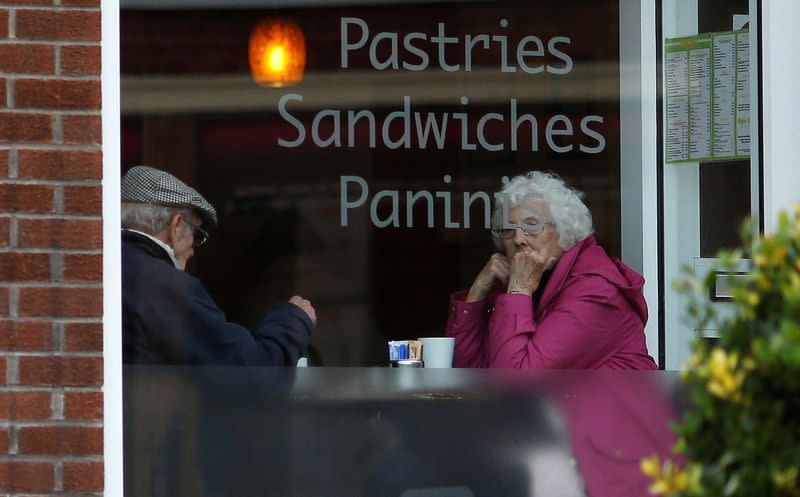 FILE PHOTO: An elderly couple sit inside a coffee shop