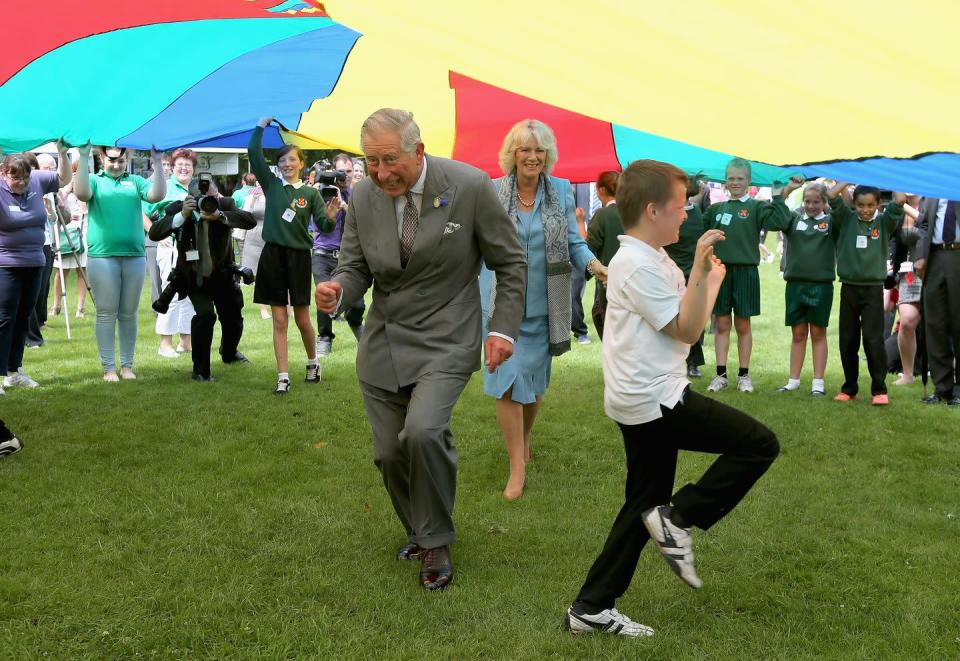 <p>Charles and Camilla got a little goofy during a youth showcase parachute game. </p>