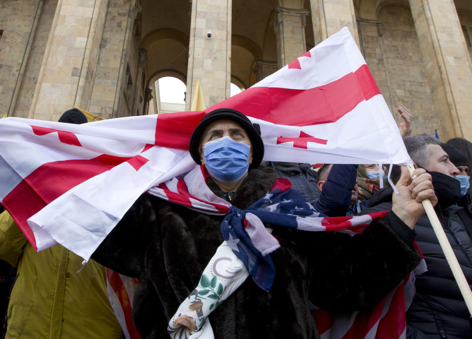 Georgian opposition activists attend a rally in support of the United National Movement party leader Nika Melia in front of the parliament's building in Tbilisi, Georgia, Friday, Feb. 26, 2021. The rally came after police stormed on Tuesday the headquarters of the United National Movement and arrested its chairman, lawmaker Nika Melia. (AP Photo/Shakh Aivazov)