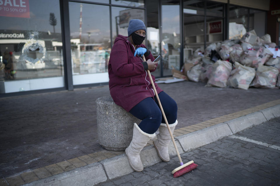 Volunteers participate in the cleaning efforts at Soweto's Diepkloof mall outside Johannesburg, South Africa, Thursday, July 15, 2021. A massive cleaning effort has started following days of violence in Gauteng and KwaZulu-Natal provinces. The violence erupted last week after Zuma began serving a 15-month sentence for contempt of court for refusing to comply with a court order to testify at a state-backed inquiry investigating allegations of corruption while he was president from 2009 to 2018. (AP Photo/Jerome Delay)