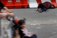 A man lays on the street outside Pennsylvania Station transit hub in New York City