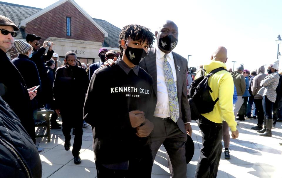 Civil Rights Attorney Ben Crump (right) hustles Z'Kye Husain away from a news conference outside the Bridgewater Township, NJ, police station that was taken over by another groupl Wednesday, March 2, 2022.  Crump claims that Husain was a victim of explicit bias and excessive force when he was slammed to the ground, face first, with a knee put on his back after a fight at the Bridgewater Mall.