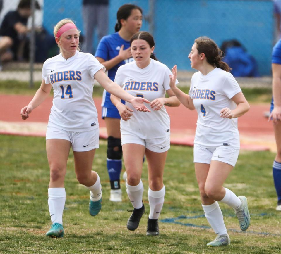 Caesar Rodney's (from left) Alexandra LeNoir, Allyson Durham and Alexandra Soghomonian celebrate the opening goal, finished by Soghomonian, in Charter School of Wilmington's late comeback win, 3-2, Wednesday, March 22, 2023 in Wilmington.