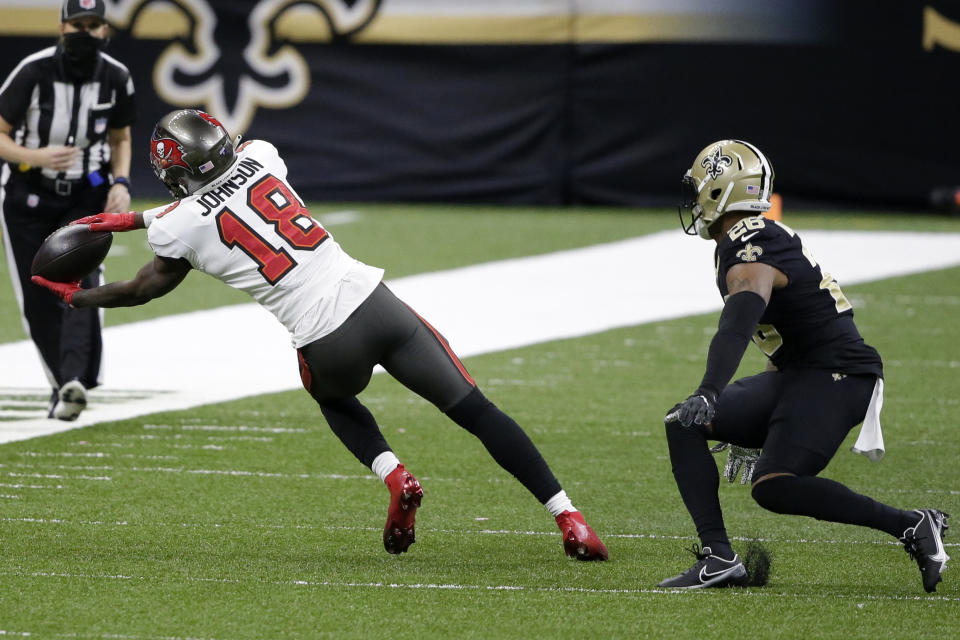 Tampa Bay Buccaneers wide receiver Tyler Johnson (18) makes the catch against New Orleans Saints free safety P.J. Williams (26) during the second half of an NFL divisional round playoff football game, Sunday, Jan. 17, 2021, in New Orleans. (AP Photo/Butch Dill)