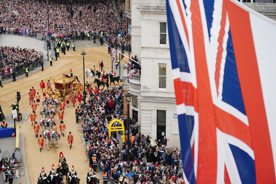 The Gold State Coach approaches The Mall during the Platinum Jubilee Pageant outside Buckingham Palace in London, Sunday June 5, 2022, on the last of four days of celebrations to mark the Platinum Jubilee. The pageant will be a carnival procession up The Mall featuring giant puppets and celebrities that will depict key moments from the Queen Elizabeth II's seven decades on the throne. (Dominic Lipinski/PA via AP)