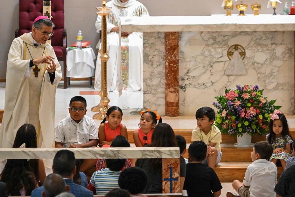 Father Eduardo Morales speaks to children as US President Joe Biden and First Lady Jill Biden attend Mass at Sacred Heart Catholic Church in Uvalde, Texas on May 29, 2022 (AFP via Getty Images)
