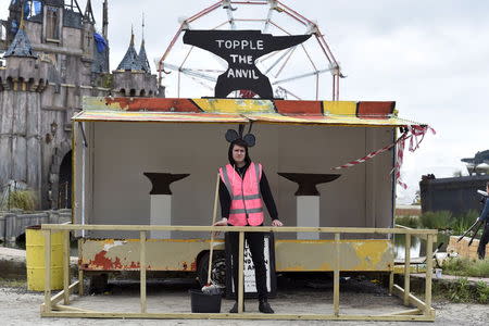 A performer stands at a booth in 'Dismaland', a theme park-styled art installation by British artist Banksy, at Weston-Super-Mare in southwest England, Britain, August 20, 2015. REUTERS/Toby Melville