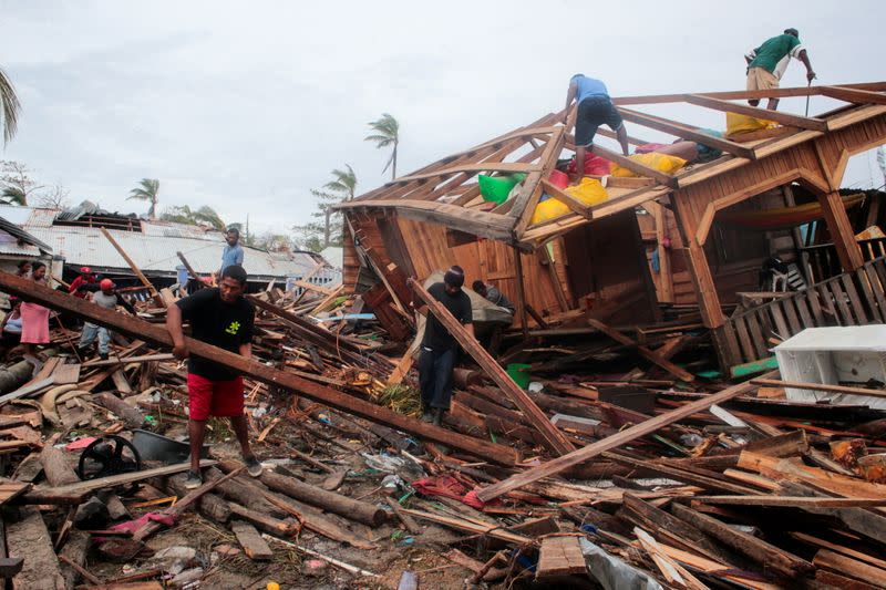 Residents remove debris from their houses destroyed by the passing of Hurricane Iota, in Puerto Cabezas