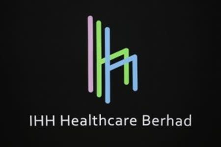 The logo of IHH Healthcare Berhad (IHH) is seen at the Singapore Exchange before its listing, July 25, 2012. REUTERS/Tim Chong/Files