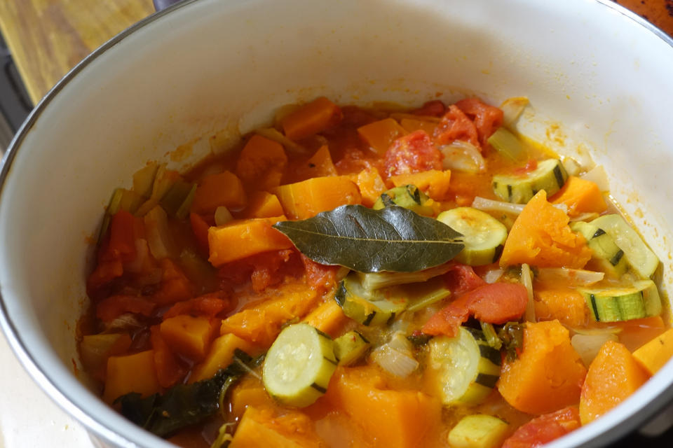 A bowl of vegetable stew with bay leaf