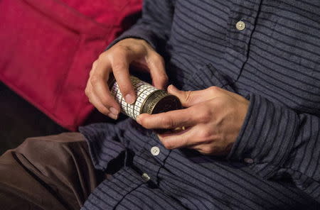 A man works to solve a puzzle to escape from a Sherlock Holmes-themed escape room in Alexandria, Virginia October 17, 2015. REUTERS/Joshua Roberts