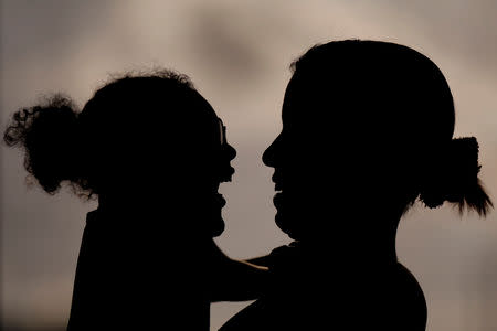 Rosana Vieira Alves, 28, smiles with her daughter two-year-old Luana Vieira, who was born with microcephaly, during an evaluation session with a physiotherapist at the Altino Ventura rehabilitation center in Recife, Brazil, August 6, 2018. Rosana has three daughters. "It's hard to manage the girls. Some of them are jealous, but Luana needs more care. In time, they'll understand." Rosana does not have any family support and is overwhelmed by the cost of housing and Luana's medicines. She counts it a victory that she has managed to get a wheelchair for Luana, and worries about the four surgeries her daughter needs to correct problems with her eyes, her gut and the position of her hips and feet. The demands have taken Rosana to some dark places, and she confesses that she has considered suicide. But she still dreams of a better future, and hopes to get a degree in accounting or civil engineering. REUTERS/Ueslei Marcelino