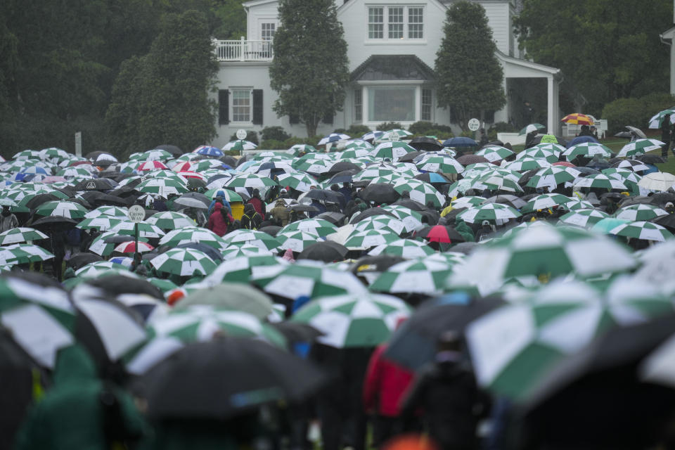 Patrons leave the course after play was suspended for the day in the weather delayed third round of the Masters golf tournament at Augusta National Golf Club on Saturday, April 8, 2023, in Augusta, Ga. (AP Photo/Mark Baker)