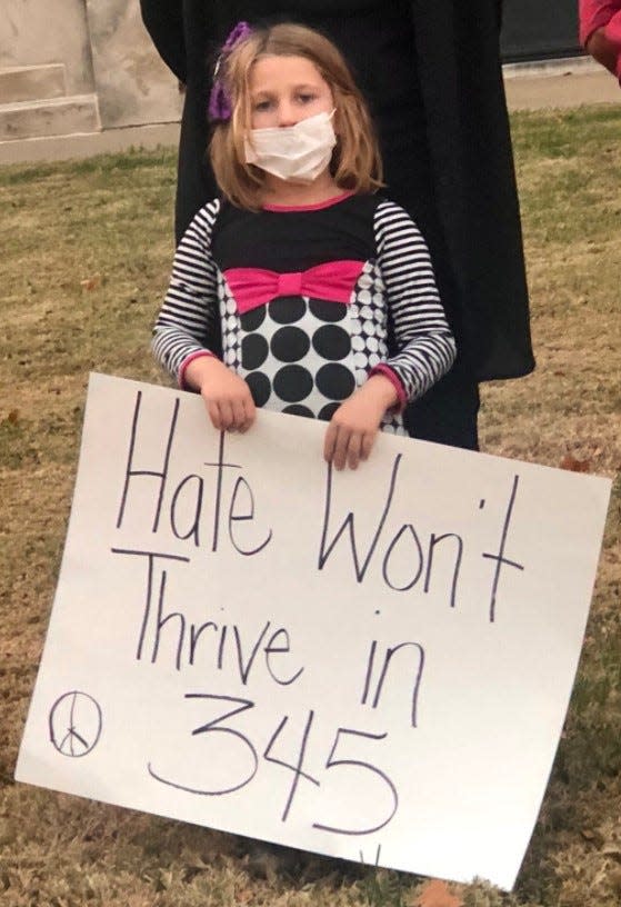 Ramona Allen, 6, held a sign during a protest urging Seaman school board members to change the district's name. The district's namesake, Fred A. Seaman, was a Ku Klux Klan leader.