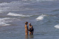 Women cool off on Puerto de Sagunto beach, east Spain on Tuesday, Aug. 16, 2022. While vacationers might enjoy the Mediterranean sea’s summer warmth, climate scientists are warning of dire consequences for its marine life as it burns up in a series of severe heat waves. (AP Photo/Alberto Saiz)