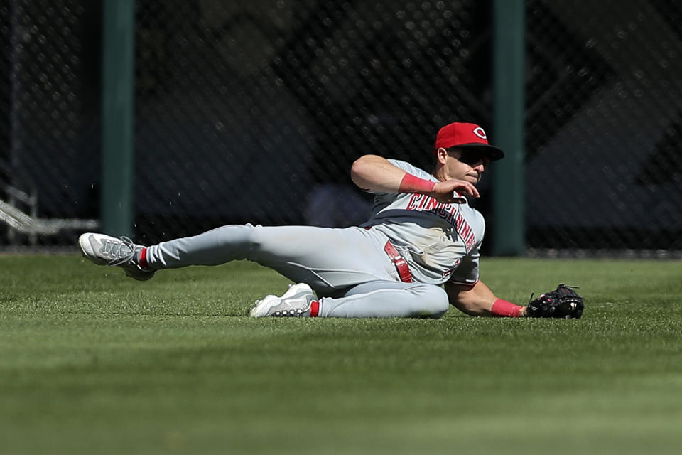 Cincinnati Reds' Spencer Steer makes a catch for an out during the sixth inning of a baseball game against the Chicago White Sox, Saturday, April 13, 2024, in Chicago. (AP Photo/Melissa Tamez)