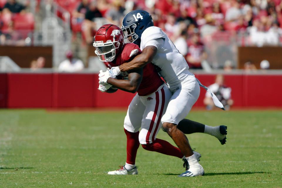 Arkansas receiver De'Vion Warren (10) is tackled by Georgia Southern cornerback Darrell Baker Jr. (14) during a game on Sept. 18, 2021 in Fayetteville, Ark.