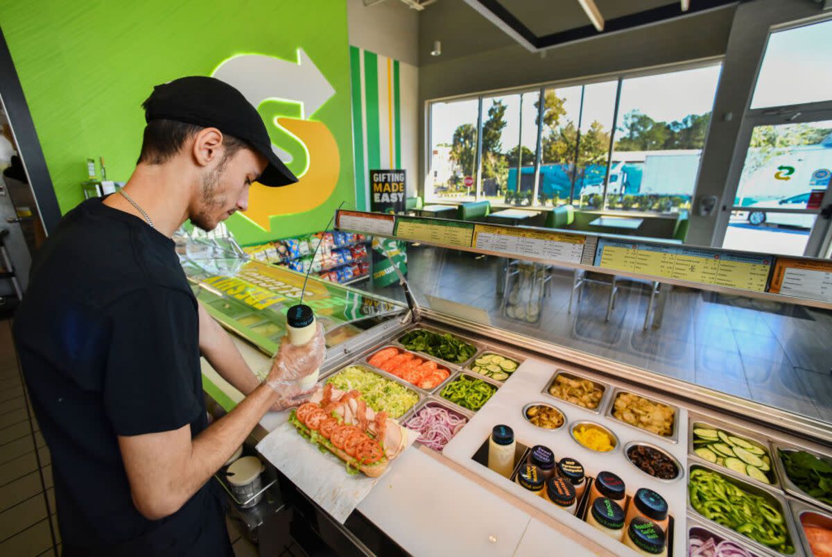 Man Making a Sandwich Behind the Counter at Subway, Crystal River, Florida